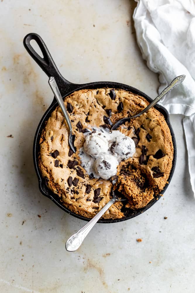 Skillet cookie with 3 spoons digging into it