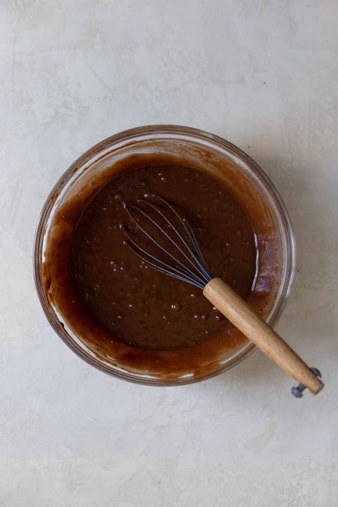 Chocolate cake batter in a glass bowl