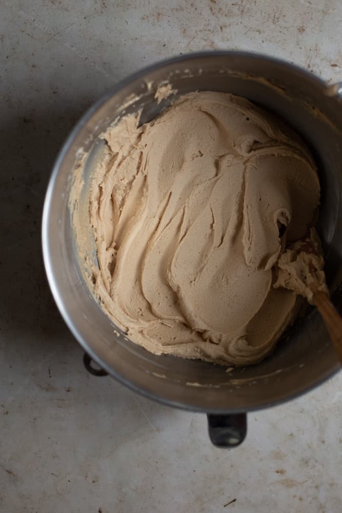 Cookie butter buttercream smoothed out in a mixing bowl