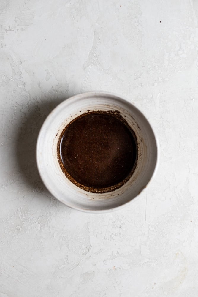 Brewed Coffee mixed with instant espresso in a bowl on a grey surface