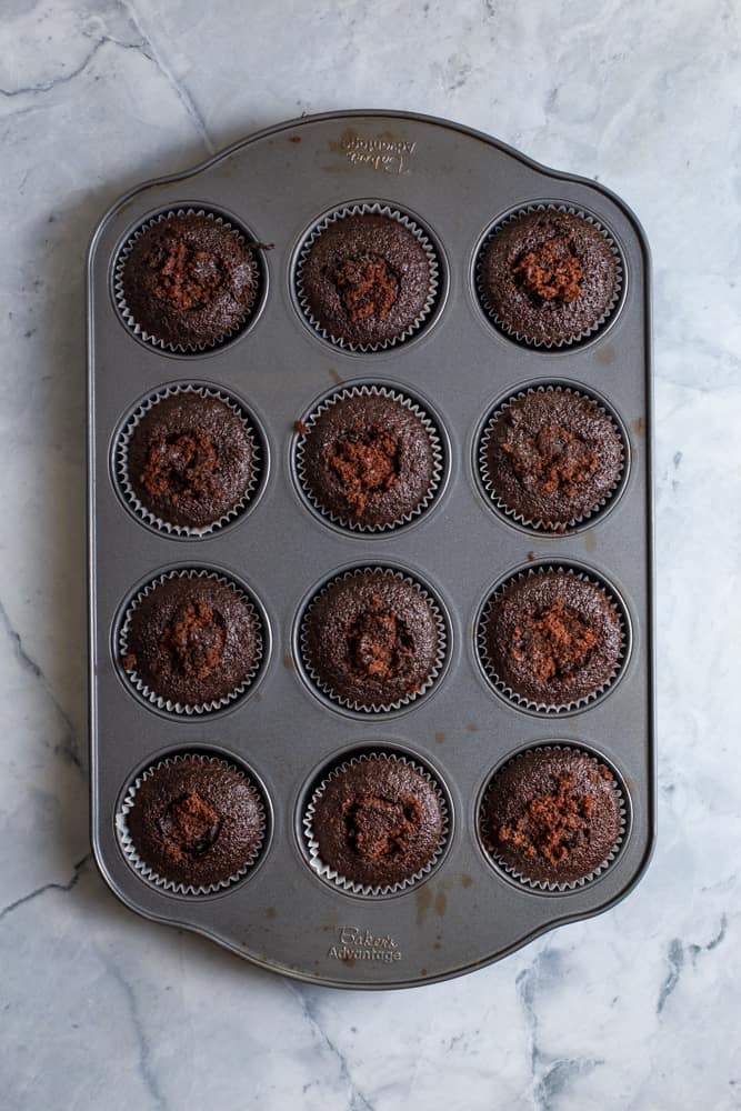 chocolate cupcakes filled with ganache in a 12 pan cupcake tin