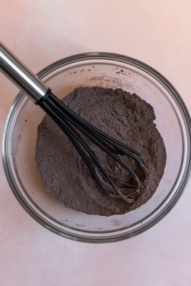 Dry ingredients for chocolate cupcakes in a glass bowl