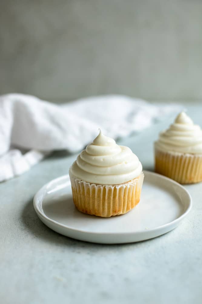 A cupcales with cream cheese frosting piped on top
