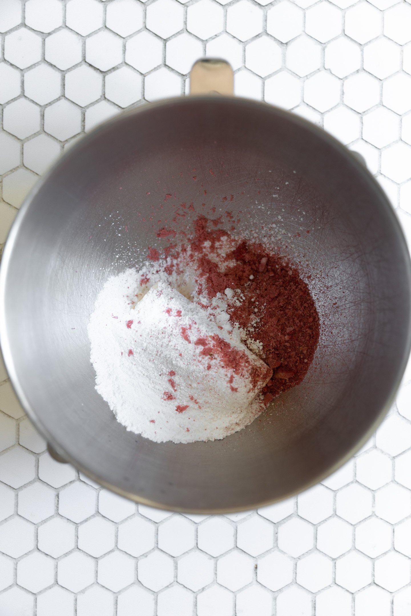 Powdered sugar and freeze dried strawberries in a bowl.