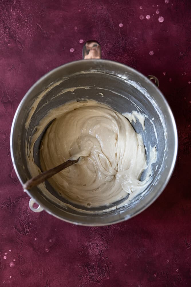 Vanilla cupcake batter in a stainless steel bowl.