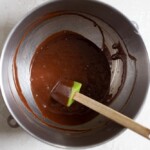 Chocolate batter in a stainless steel bowl