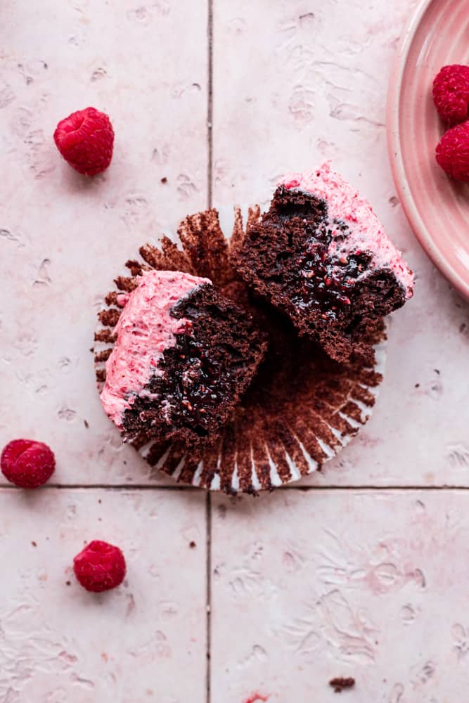 A chocolate raspberry filled cupcake sliced in half