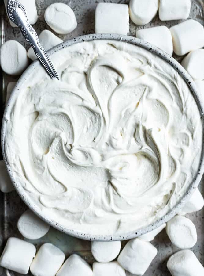 A close up of a bowl with marshmallow frosting swirled inside