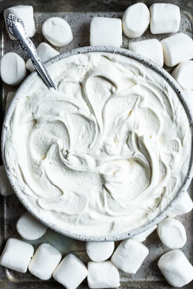 A close up of a bowl with marshmallow frosting swirled inside