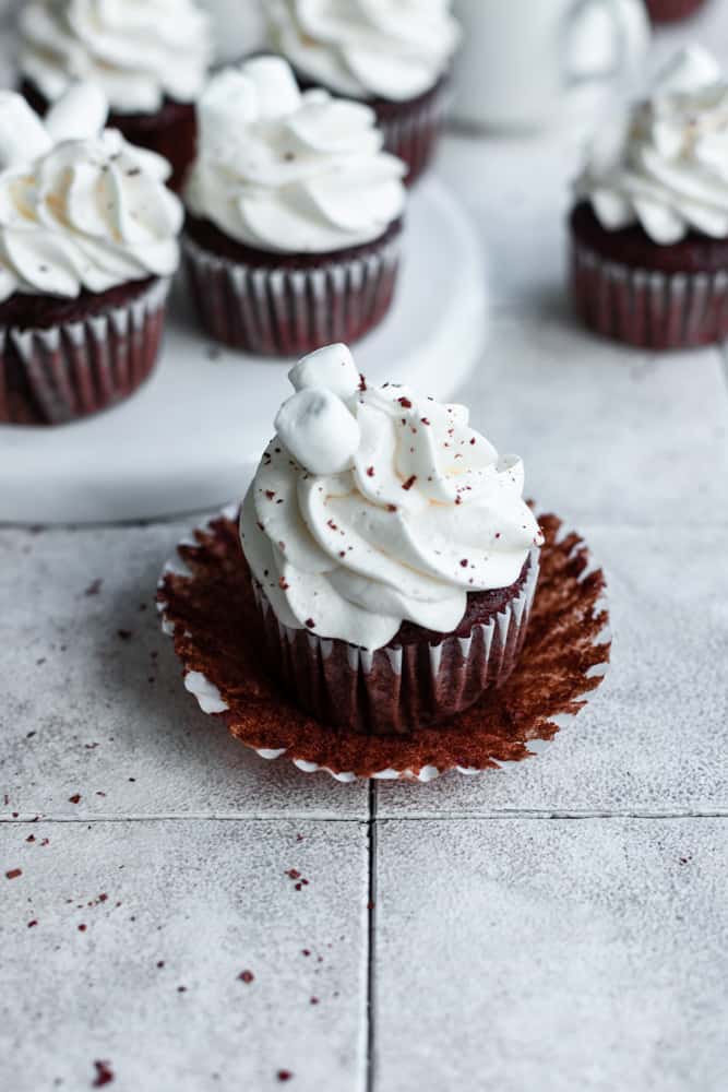 A chocolate cupcake covered with marshmallow frosting