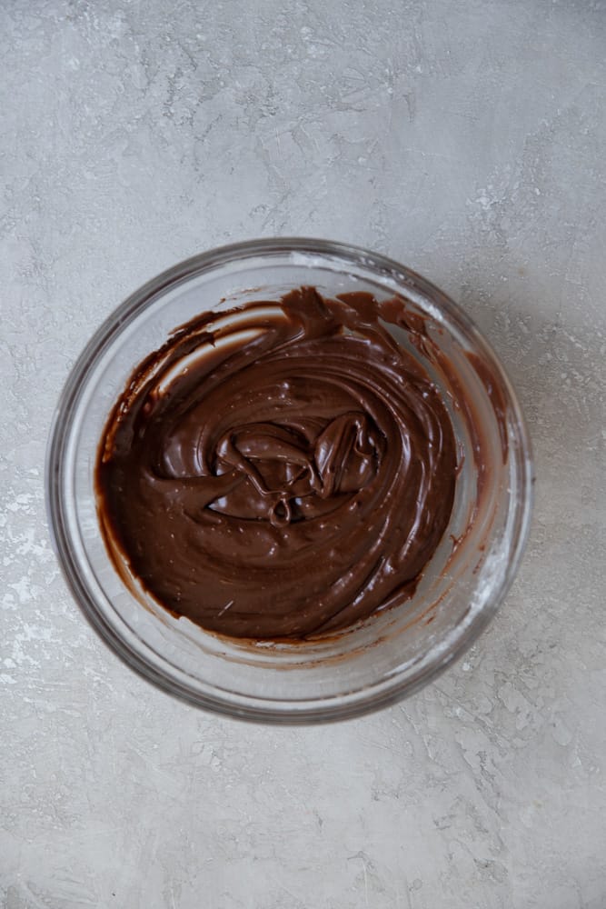 chocolate frosting in a small glass bowl