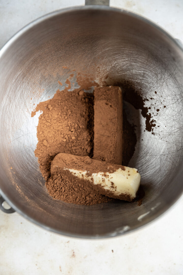 Butter and cocoa powder in a mixing bowl.