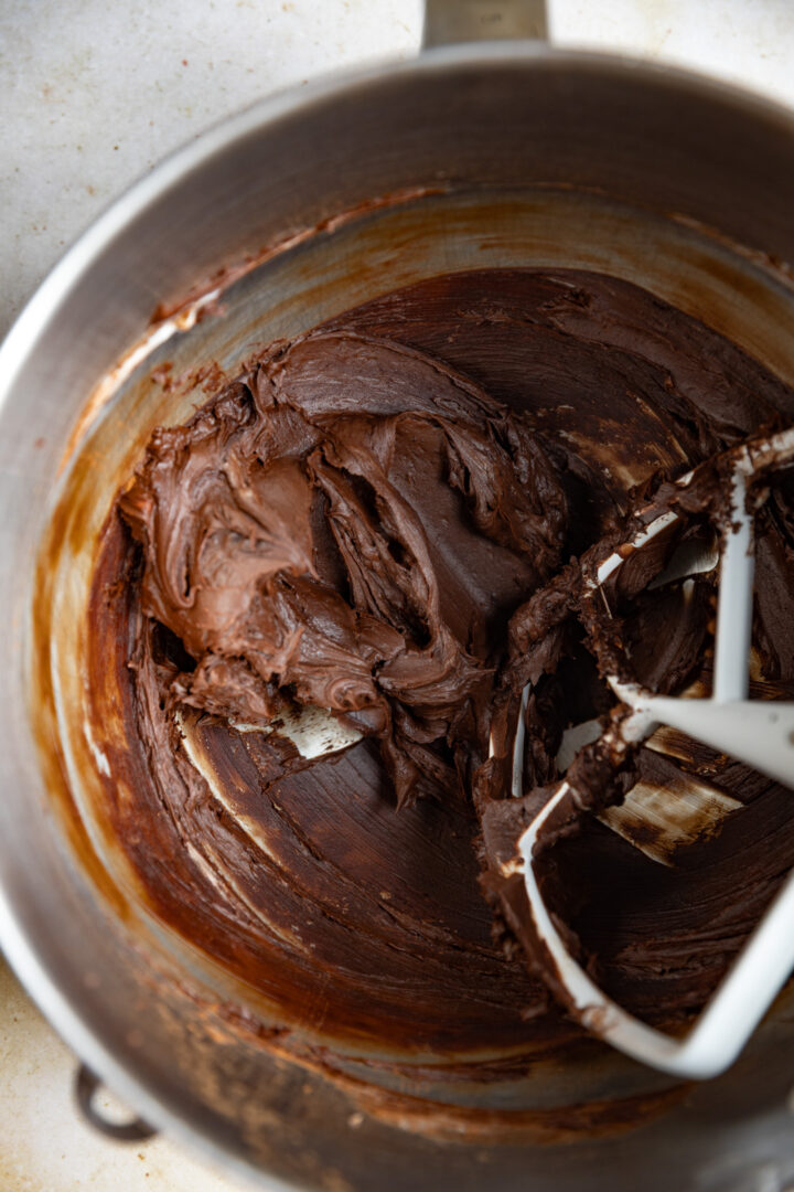 Creamed butter and cocoa powder in a mixing bowl.