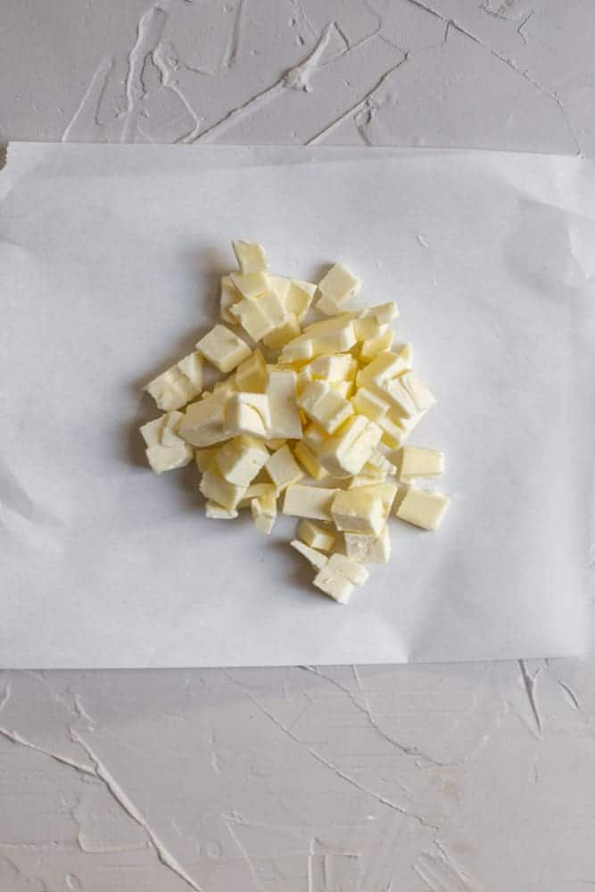 Diced butter on a piece of parchment paper. 
