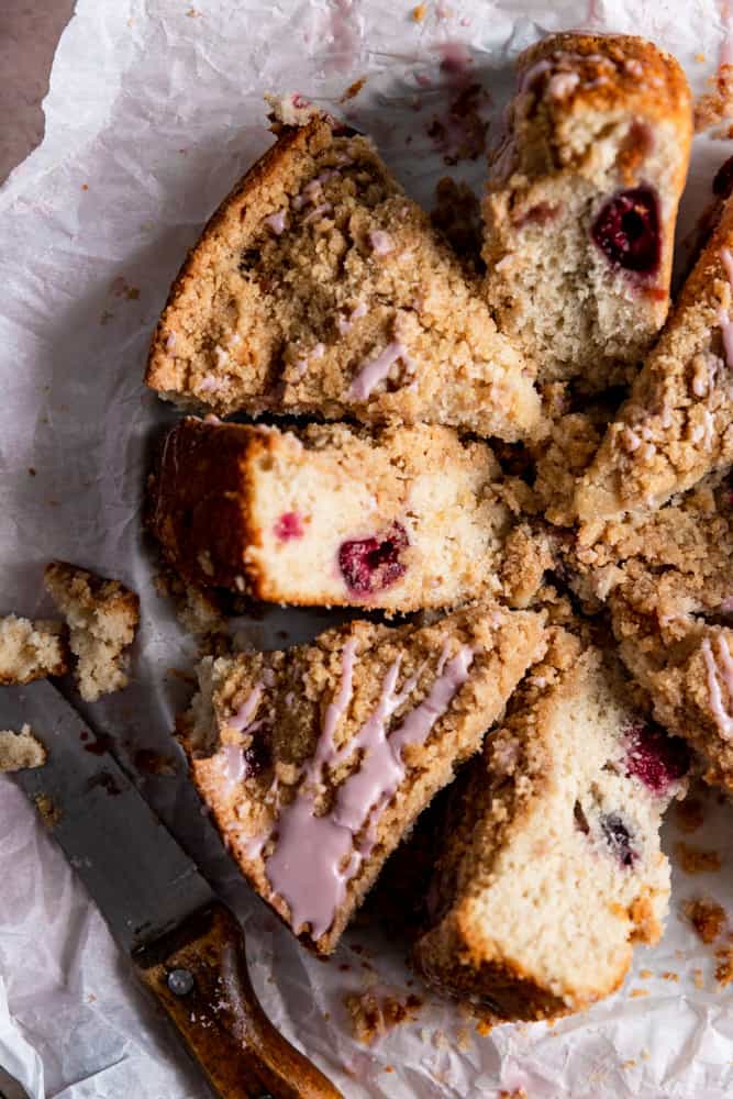 Slices of cherry coffee cake on a piece of parchment paper.