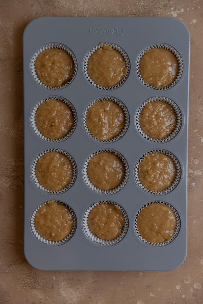 Coffee cake muffin batter in a muffin tin.