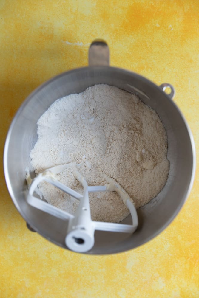 Butter combined with dry ingredients in a mixing bowl. 