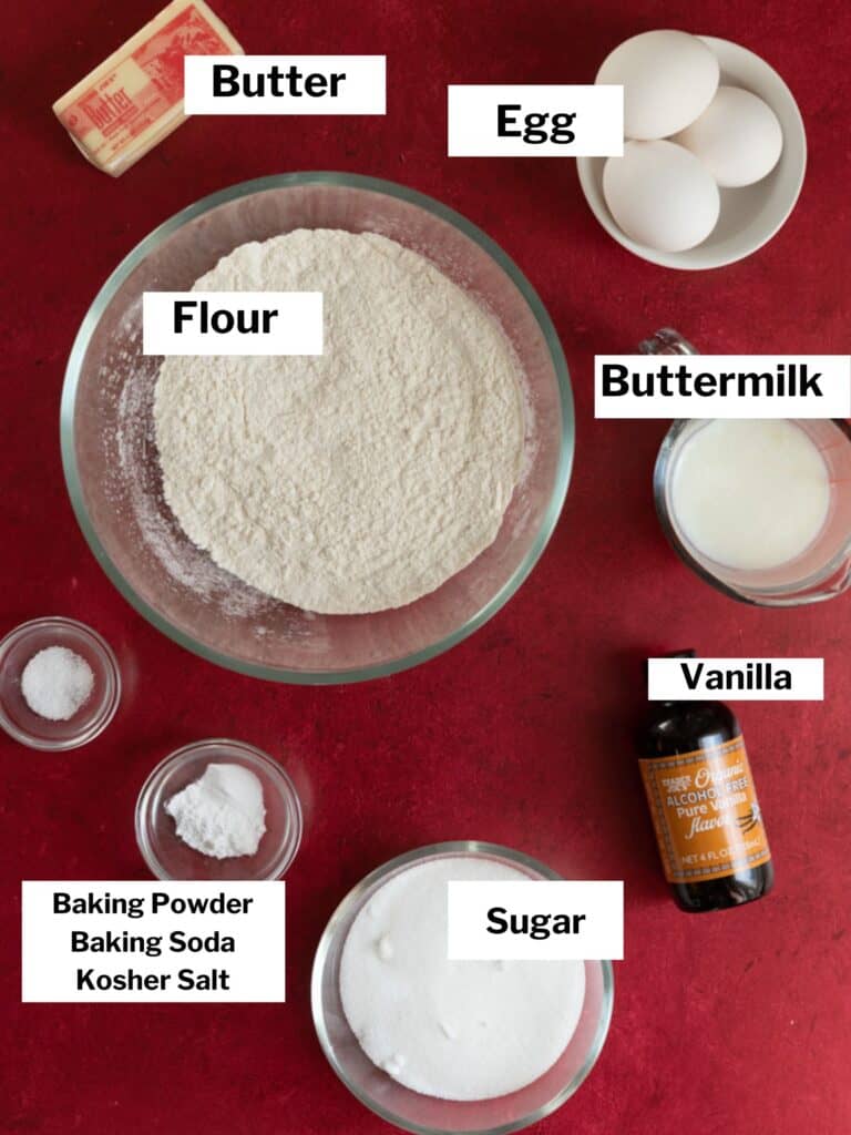 Ingredients for cupcakes on a red surface.
