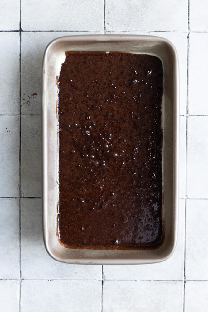 Chocolate batter in a loaf pan.