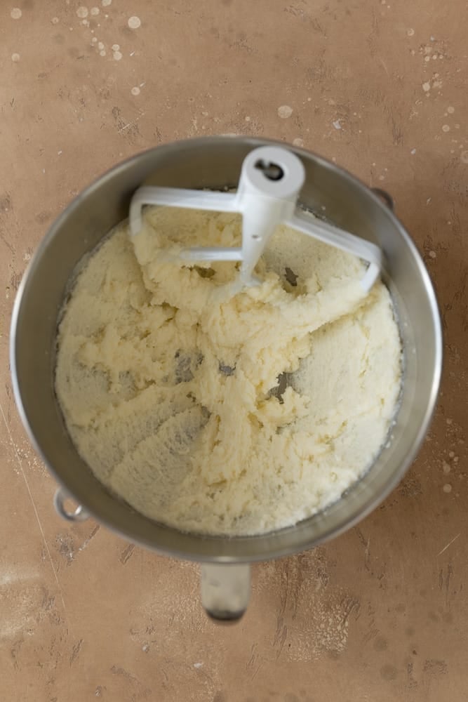 Whipped butter and sugar in a mixing bowl.