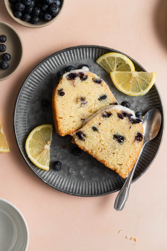 Two slices of lemon blueberry bundt cake on a plate.