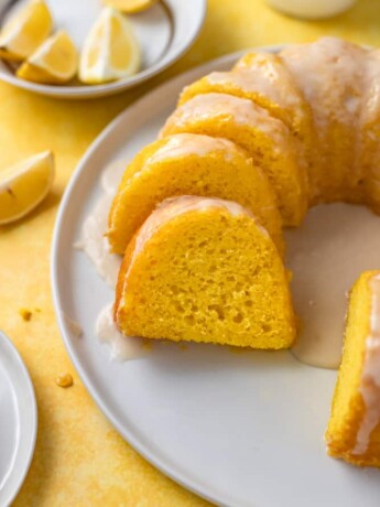 Slices of lemon bundt cake on a round white plate.