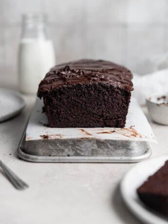 A chocolate loaf cake on a small sheet tray.