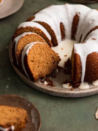 A sliced bundt cake with a slice on it's side.