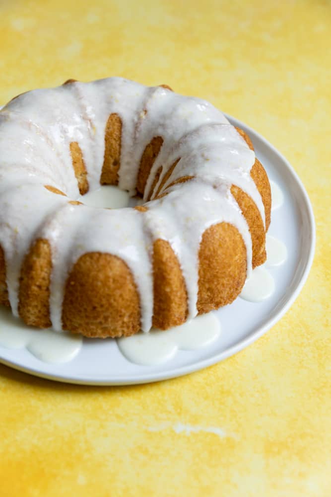 A close up of a bundt cake topped with a white glaze.