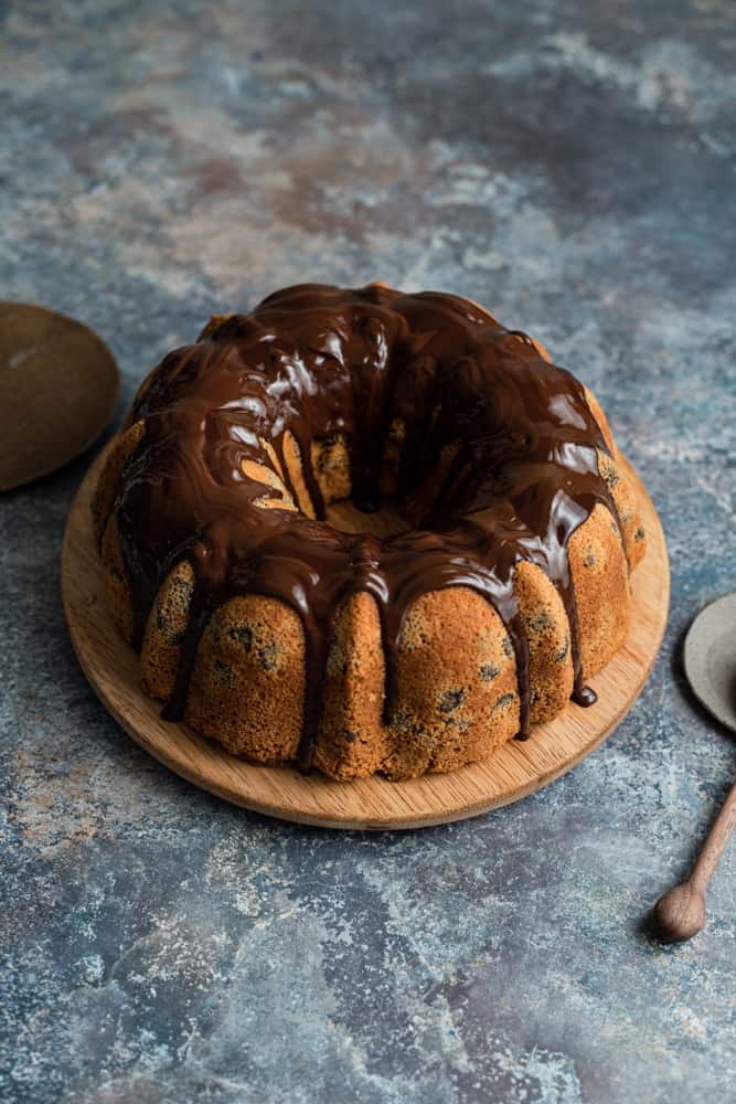 A bundt cake with chocolate drizzled on top.