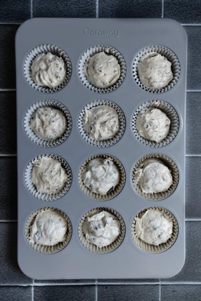 Oreo cupcake batter in a muffin tin.
