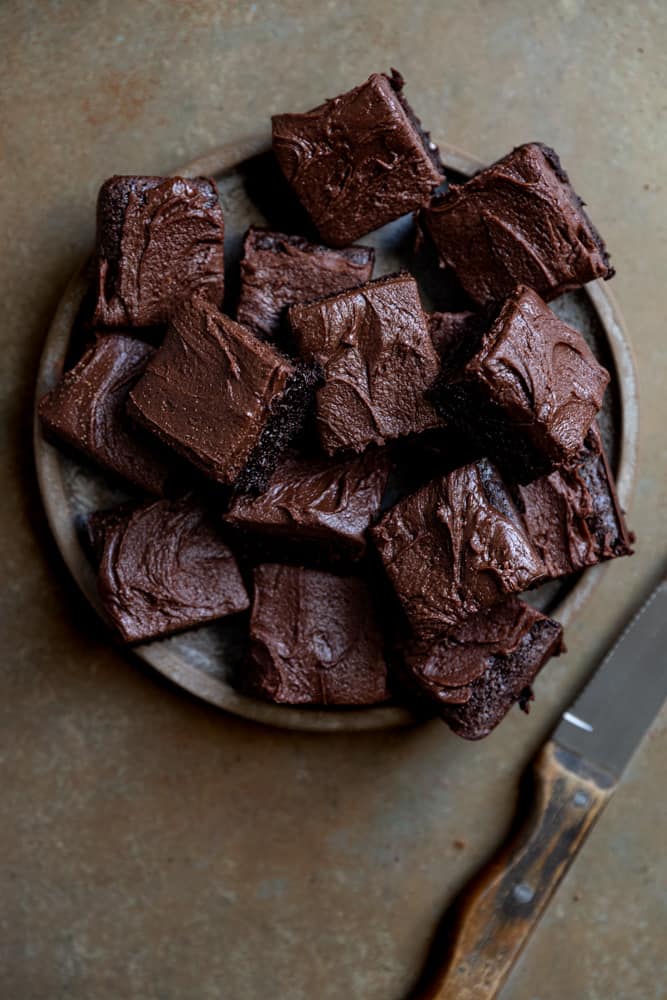 A plate stacked with brownies.