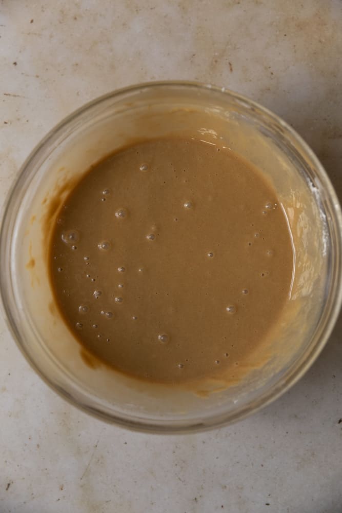Finished coffee cupcake batter in a glass bowl.
