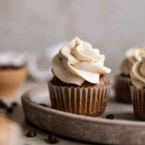 A coffee cupcake on a brown plate.