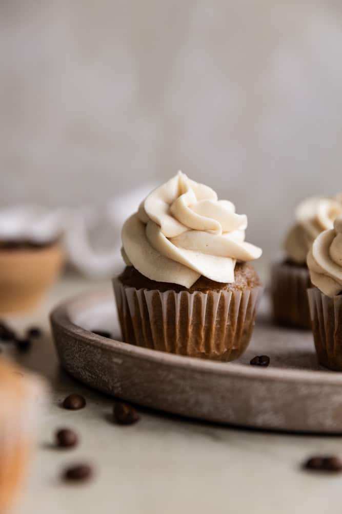 A coffee cupcake on a brown plate.