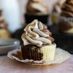 A marble cupcake with it's liner peeled down.