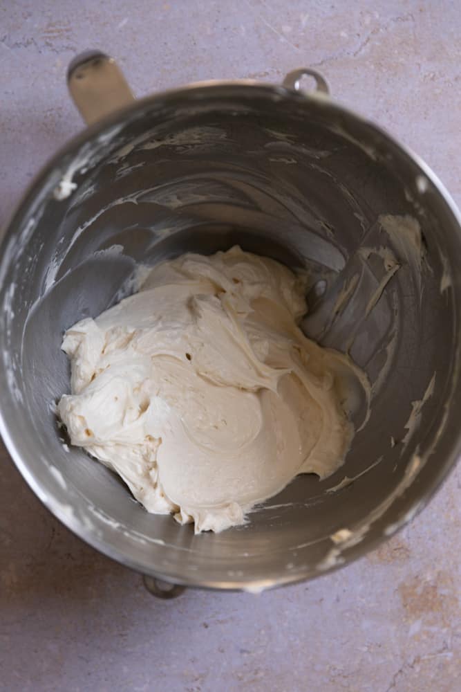 Butter and condensed milk in a mixing bowl.