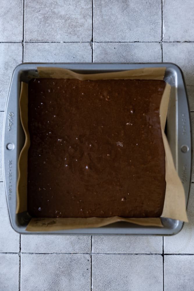 Brownie batter in a 8x8 inch pan.