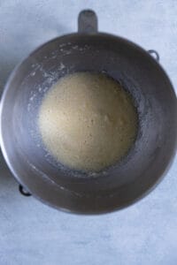 Creamed butter, sugar, and eggs in a stainless steel bowl.