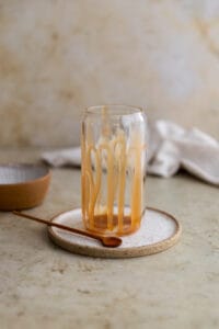 Caramel drizzled on the inside of a glass cup.