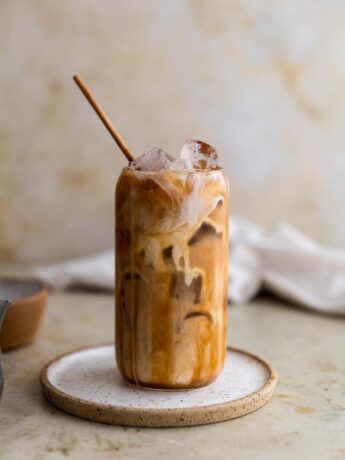 Caramel iced coffee on a white plate.