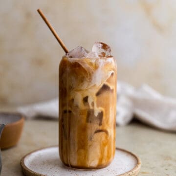 Caramel iced coffee on a white plate.