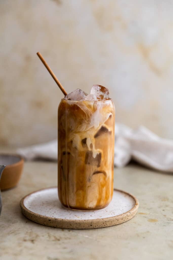 Caramel iced coffee on a white plate.