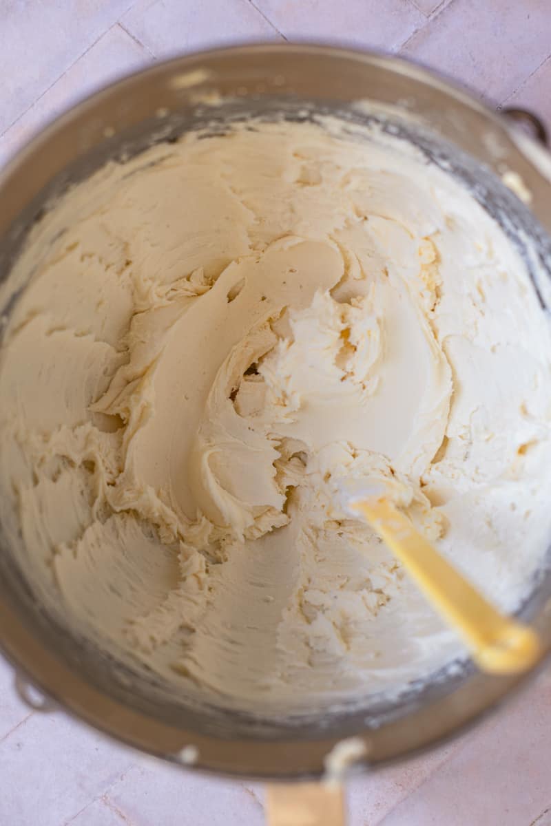 Vegan frosting and a spatula in a mixing bowl.