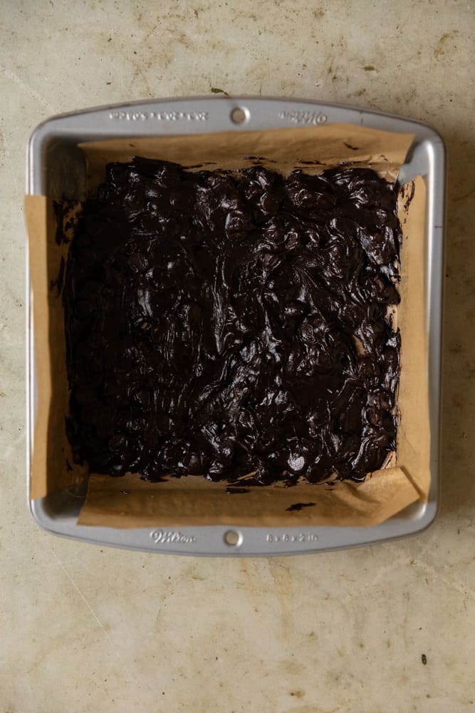 A pan lined with brownie batter.