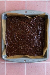 Brownies batter with sprinkles in an 8x8 pan.