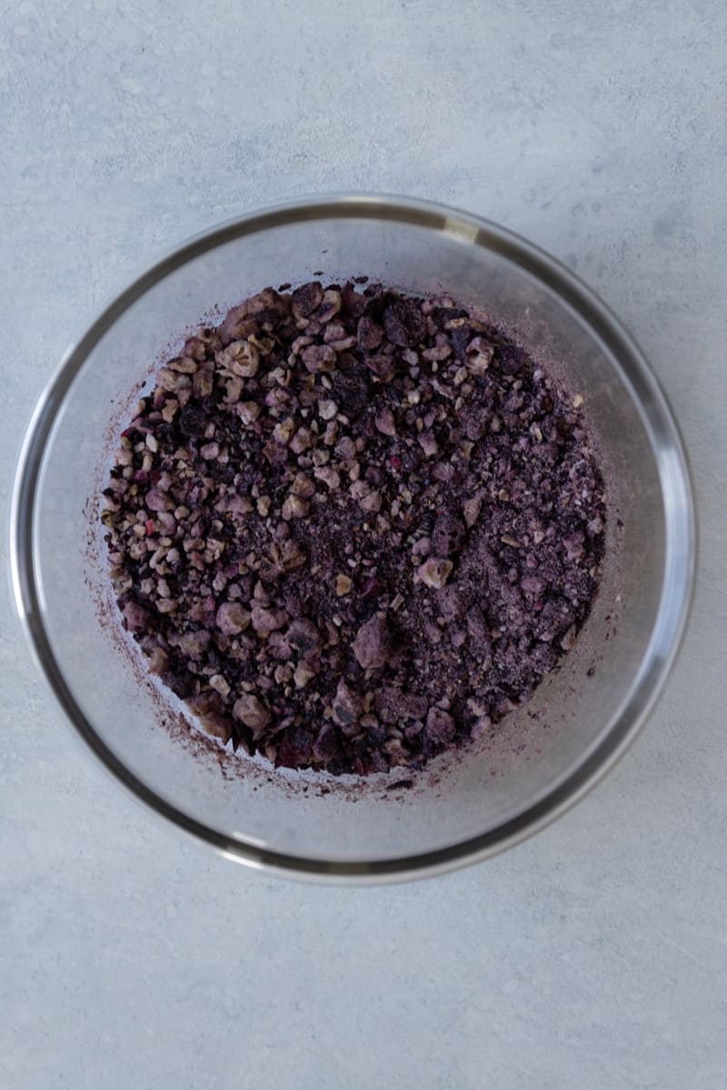 Pulverized freeze dried blueberries in a small bowl.