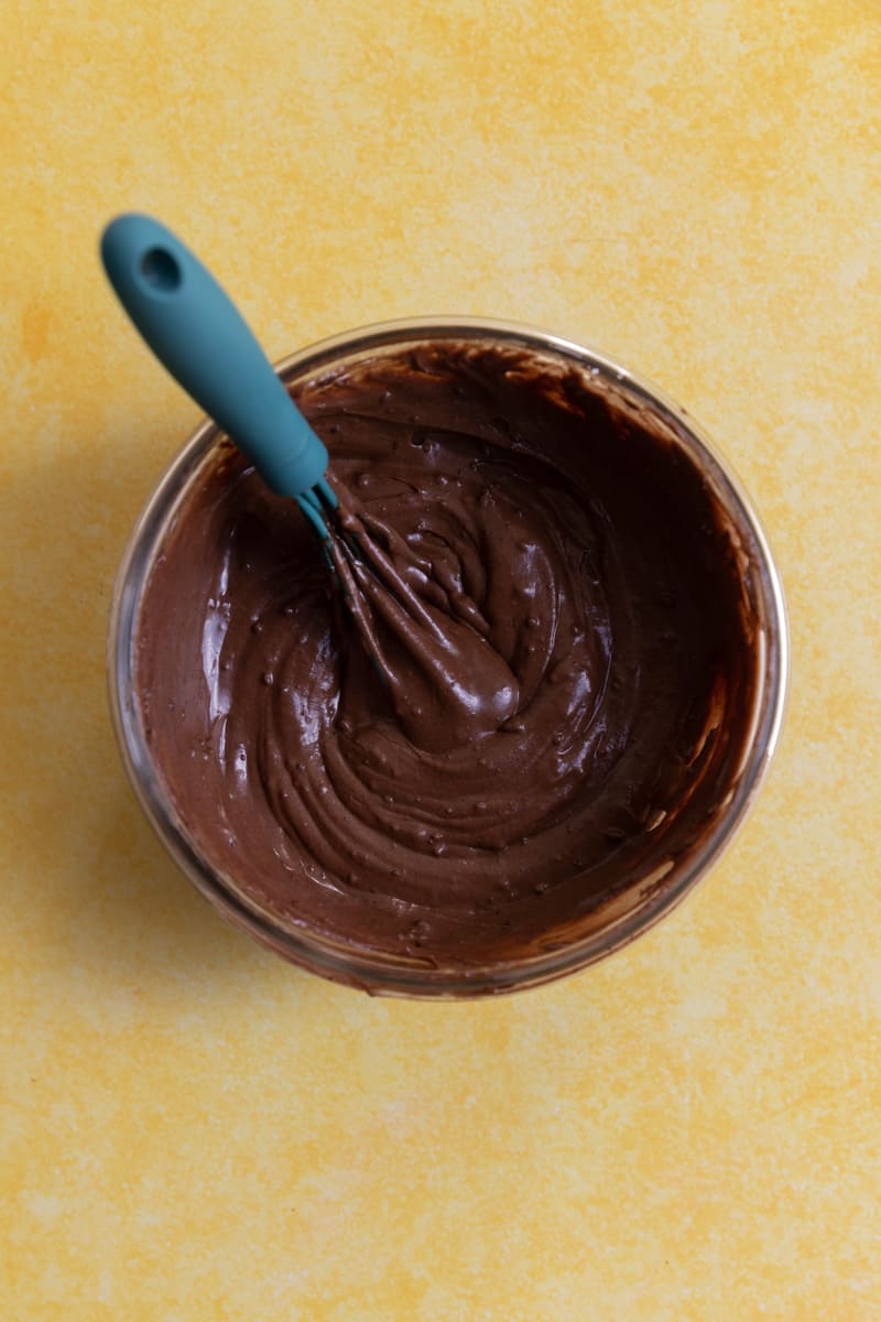 Brownie frosting in a glass bowl.