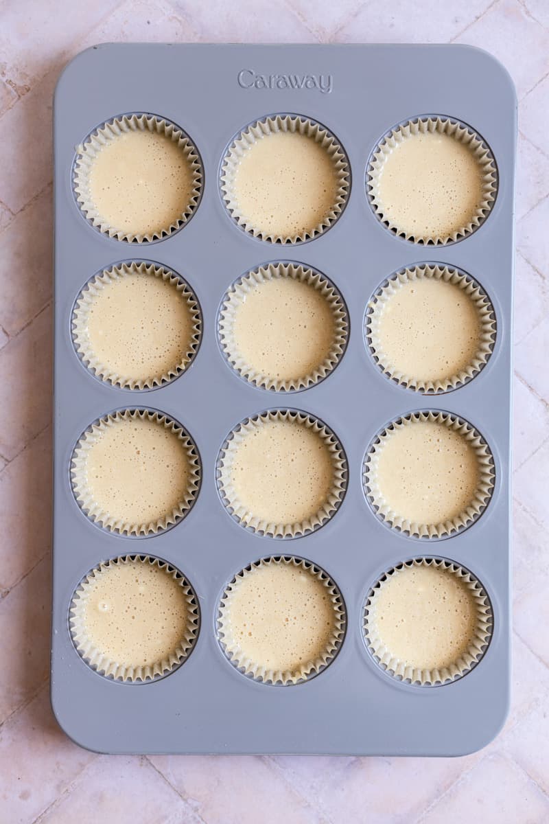A muffin tin filled with cupcake batter.