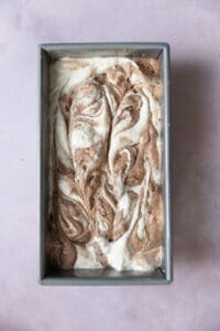 Swirled vanilla and chocolate batter in a loaf pan.